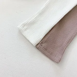 Detailed close-up of high-elasticity ribbed knit fabric with neat double-needle stitching