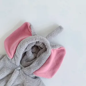 Detail of plush baby elephant onesie with soft 3D ears and pink interior lining