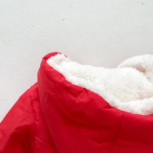 Close-up of winter baby jacket showing soft white sherpa lining and red windproof outer fabric
