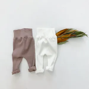 Detail of high waist ribbed baby leggings in dusty pink and white cotton blend fabric
