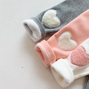Toddler thermal leggings with fleece lining and plush heart patches in grey, pink, and white