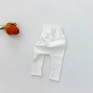Detail of baby high waist leggings in white ribbed knit cotton with protective belly band