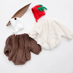 Flat lay detail of plush long sleeve baby rompers with matching warm hats for winter