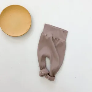 Close-up of baby ribbed high-waist leggings in soft mauve with a natural rolled hem