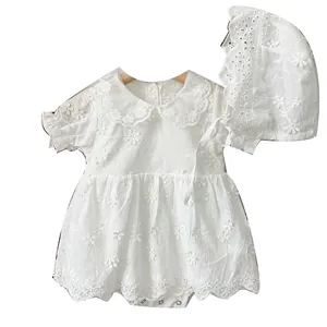 White embroidered baby girl romper with floral lace collar and matching sun hat on wooden hanger