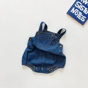 Detail of baby denim romper with metal buckles, side pocket and snap button crotch