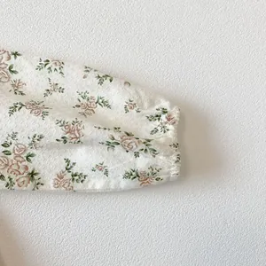 Detailed close-up of elastic floral cuffs with delicate pink rose pattern and texture