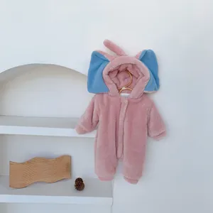 Close-up of baby romper showing soft pink fleece texture and elephant hood design