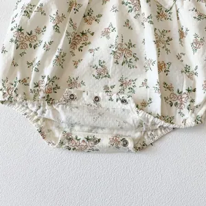 Close-up of baby floral cotton romper featuring snap button crotch for easy diaper changes