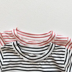 Detail of round neckline with reinforced stitching on cotton striped baby bodysuit