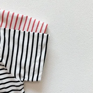 Close-up of cotton striped baby t-shirt showing neat stitching and soft fabric texture