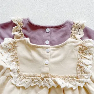 Close-up of baby romper showing delicate lace collar and soft knitted cotton fabric detail