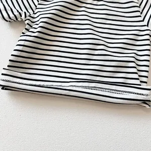 Detail of baby striped romper featuring clean white double-needle stitching on cotton fabric