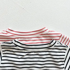 Detailed view of striped cotton baby rompers in red and black patterns with soft fabric