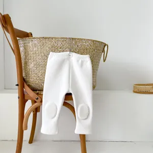 Detailed close-up of baby winter leggings featuring plush knee pads and elastic waist