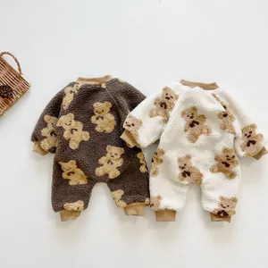 Close-up of thick sherpa fleece baby jumpsuits with cute bear patterns and ribbed cuffs