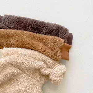 Close-up of thick winter baby romper showing ribbed cuffs and soft fleece texture