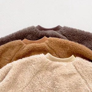 Detail of soft teddy fleece baby jumpers in coffee, caramel, and cream colors
