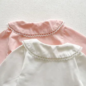 Detailed close-up of Peter Pan collar with delicate lace trim on cotton baby shirts