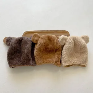 Detail of plush bear ear hats in brown, caramel, and cream for autumn and winter outfits