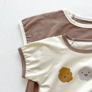 Close-up of baby raglan sleeve cotton bodysuits with cute cartoon smiling clouds