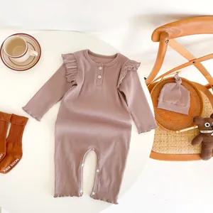 Detail of baby long-sleeve romper with ruffled shoulders and matching socks set