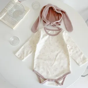 Detail of infant long sleeve bunny romper with matching pink long ear rabbit hat