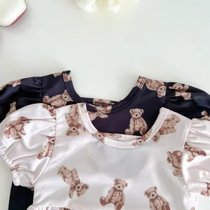 Detail of baby swimsuit with bear print, bubble sleeves, and round neckline design