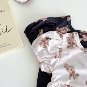 Detail of short-sleeve girls' swimsuits with cute bear prints and puff sleeves