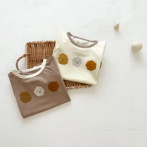 Detail view of cotton baby bodysuits with floral prints and contrast neckline binding