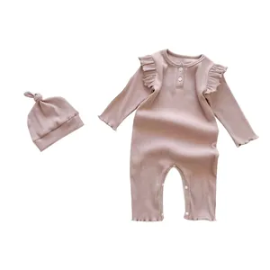 Pink ribbed cotton long-sleeve baby romper with ruffled shoulders and matching knotted hat