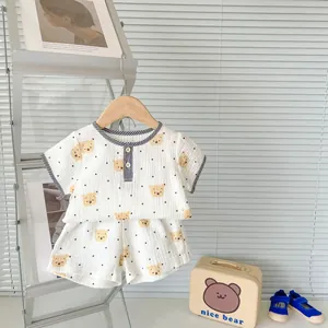 Detail of infant summer cotton gauze set with bear prints and plaid collar detail