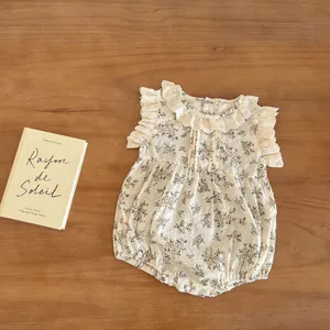 Close-up of floral baby romper featuring lace ruffled collar and bottom snap buttons