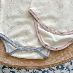 Detail of baby cotton bodysuits showing soft ribbed edges and snap button closures