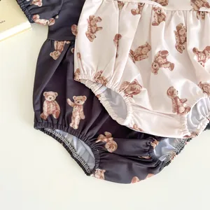 Detail of baby swimsuits with teddy bear print and elasticated ruffled edges