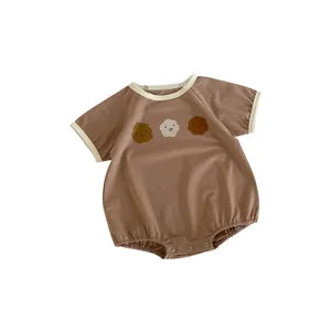 Short-sleeve cotton baby romper in brown with cute cartoon faces and snap buttons
