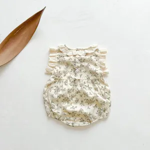 Close-up of vintage floral cotton baby romper with lace collar and ruffle sleeves