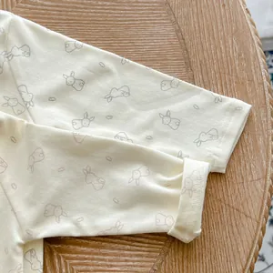 Close-up of baby romper sleeve cuff in soft cotton fabric with cute rabbit prints