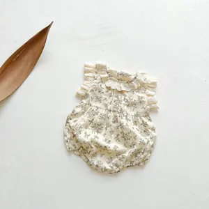 Detail of vintage floral baby romper showing lace collar and ruffled sleeve textures
