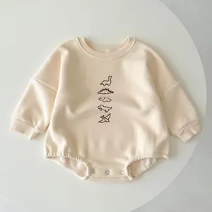 Thick winter baby dinosaur romper in beige cotton with long sleeves and snap buttons