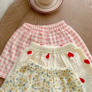 Three-pack of baby muslin cotton shorts featuring floral, heart, and checkered patterns