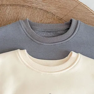 Close-up of baby sweatshirts with ribbed crew neck and warm fleece lining for winter