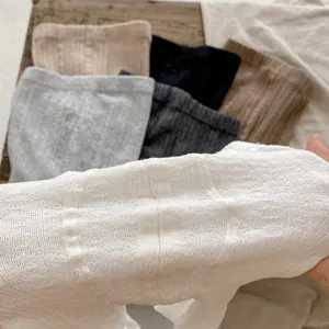 Close-up of ribbed knit texture on stretch leggings in multiple neutral colors