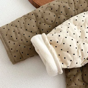 Detailed macro of polka dot quilted baby jacket with warm fleece lining texture