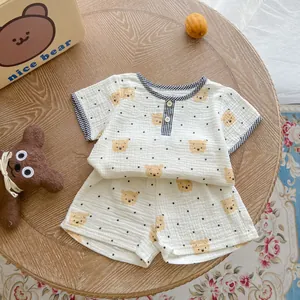 Detail of baby cotton gauze summer set with cute bear print and plaid trim edging