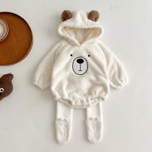 Detail of plush baby bear outfit set with hooded embroidery and soft fleece texture