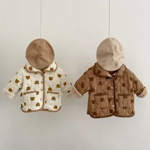 Detail of quilted baby winter jackets with bear prints and warm faux shearling lining