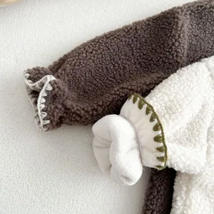 Detail of warm sherpa fleece baby romper showing decorative stitching and thick plush lining