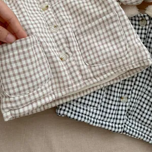 Detail view of plaid baby vests with warm fleece lining and single-breasted buttons