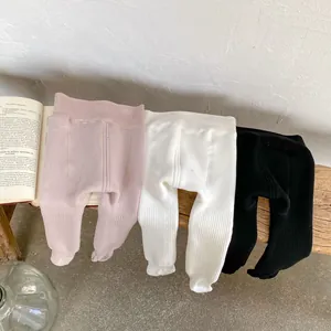 Three-pack of warm ribbed baby leggings in pink, white and black for winter comfort
